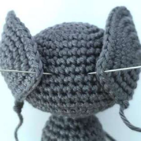 Both crochet bat ears pinned at their back corners between rounds 8 and 9