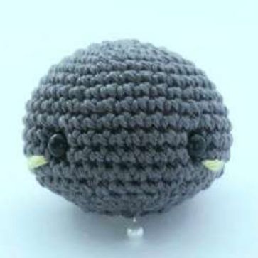 Crochet bat head with lime blush on both cheeks, ready to sew to the body