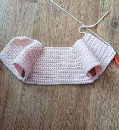 Pink crochet cardigan top with two armhole openings after dividing