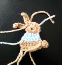 Crochet bunny with the small cluster foot at the bottom