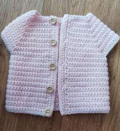 Pink crochet cardigan buttoned with wooden buttons