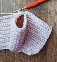 Pink crochet yoke folded so the front meets the back, with an armhole opening