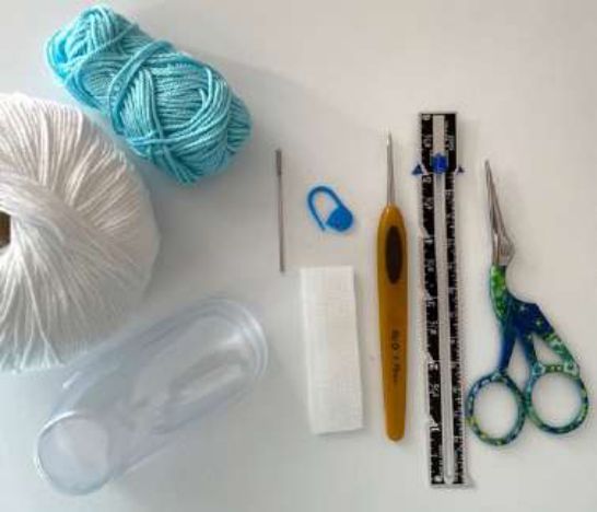 Aqua and white cotton yarn, a crochet hook, stitch markers, scissors, a ruler, hook and loop tape and a clear shoe form