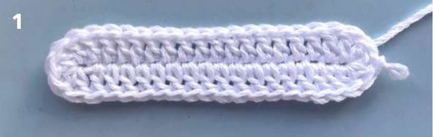 First round of a white crochet sole, worked in double crochet around a foundation chain