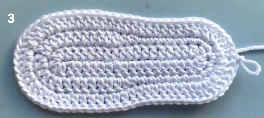 White crochet sole after round 3, wider at the toe end