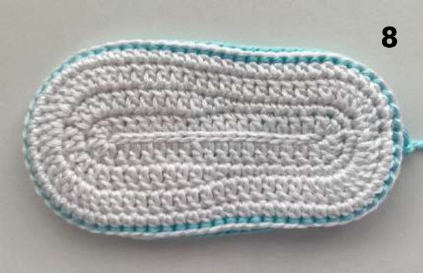 Finished white double sole with an aqua slip stitch edge all around