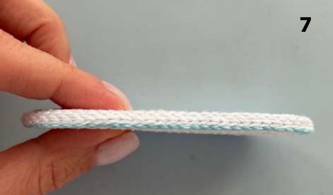 Side view of two crochet soles joined by aqua slip stitches