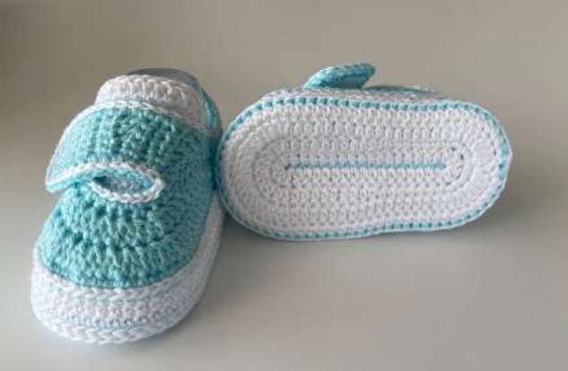 Crochet baby sneakers from the side and from below, showing the white double sole