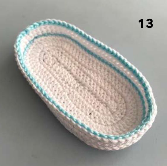Crochet sole with white sides and an aqua slip stitch edge all around the top