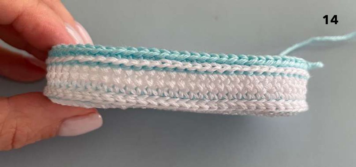 Side view of the crochet sole with the first aqua round of the shoe top