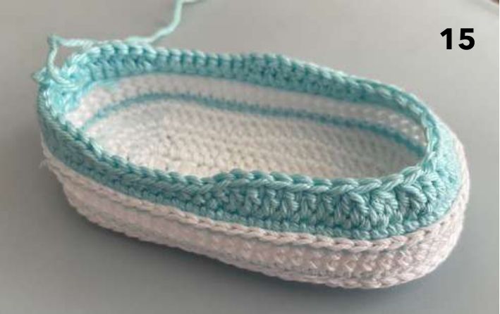 Crochet sneaker with aqua double crochet rounds starting to close in at the toe