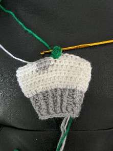 Finished green bobble on the white crochet leg