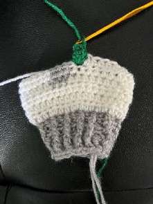 Hook going into the next stitch after a chain, beside the first green bobble
