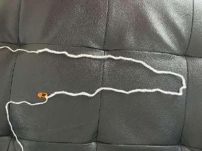 White crochet cord made of slip stitches along a long chain