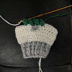 Green half double crochet worked between the bobbles from the wrong side