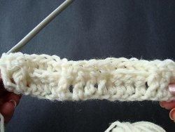 Cream crochet row of front and back post stitches on a double crochet base
