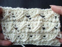 Cream crochet swatch with three rows of slanted cables