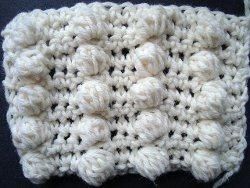 Cream crochet swatch with rows of round popcorn bobbles