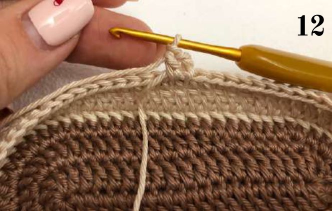 Crochet hook joining beige yarn at the edge of the shoe for the toe
