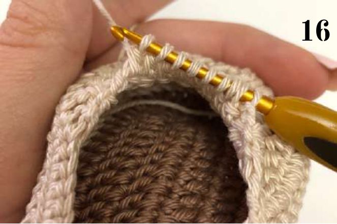 Crochet hook holding many loops while working the last stitches of the toe together