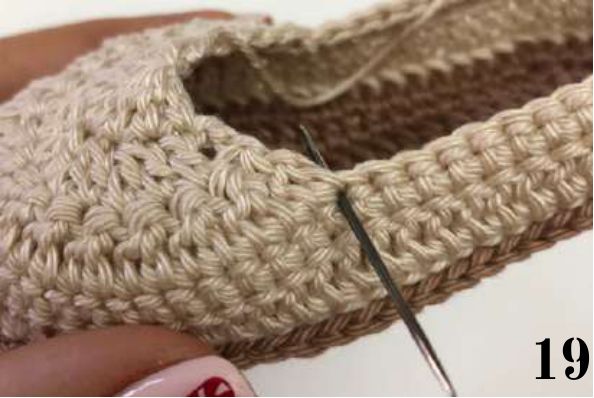 Tapestry needle pointing to the stitch where the tongue starts, beside the toe