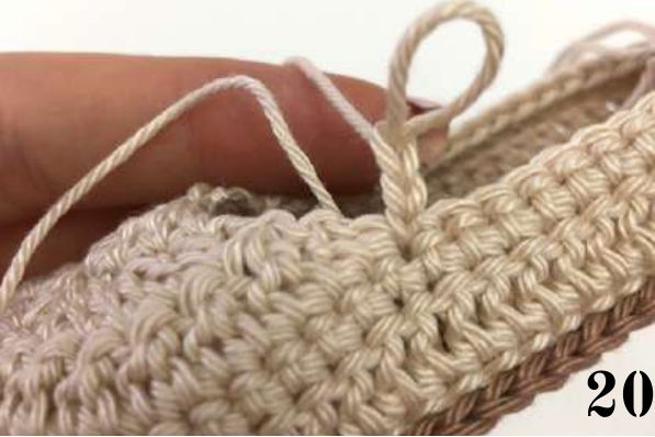 Beige yarn joined beside the toe of the crochet shoe