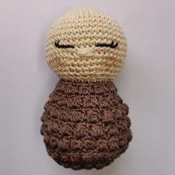 Crochet doll with embroidered sleepy eyes and nose