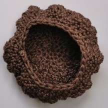 Inside of the brown crochet bobble cap, showing its rounded shape