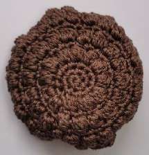 Top of the brown crochet cap with its spiral of single crochet