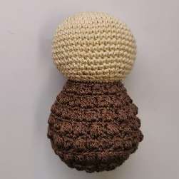 Crochet doll head sewn onto the brown bobble stitch body