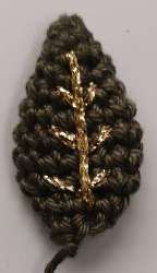 Green crochet leaf with golden embroidered veins